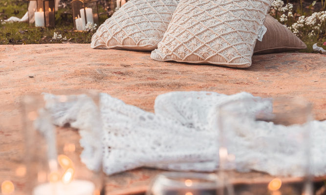 Romantic,Bohemian,Picnic,Setup,With,Candles,And,Pillows,And,Roses